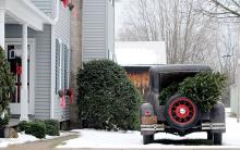 A 1930 Ford Model A coupe sits next to Linda and Alan "Buster" Dent's home at 1330 Main St, Lightstreet, with a Christmas tree in the back.
