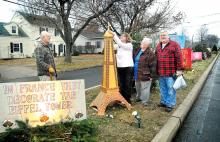 Volunteers, from left, Frank Campbell, Kimberly Young, Doreen Campbell and Rick Wynings work on the “Christmas Around the World” plot on Christmas Boulevard along Market Street in Berwick on Thursday. 
