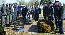 Police officers line up and salute as Rev. Caleb Fritz, of Espy Trinity United Methodist Church, leads pallbearers carrying the remains of Larry Smith to his grave at Rosemont Cemetery in Scott Township Saturday morning.