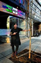 Press Enterprise/Bill Hughes Tri Pi Pizzeria owner Joe Yannone stands by the newly planted tree in front of his Main Street business in Bloomsburg on Saturday.