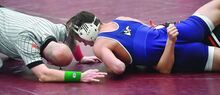 Press Enterprise/Jimmy May Central Columbia’s Crue Chipeleski, top, picks up three near fall points on Crestwood’s Mariusz Bibla during the 160-pound match during the Bob Rohm Tournament Thursday at Bloomsburg University.