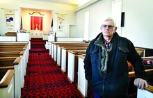 Earl Harris, Hidlay Church council president, on Friday, stands inside the small country church that is closing after 228 years. It’s the church he has been attending his entire life.