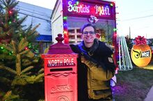 Press Enterprise/Jimmy May Kristie Rospendowski leans on the mail box for Santa and she has been responding for Santa back to kids who leave their letter for Santa at the Christmas Blvd. in Berwick. 