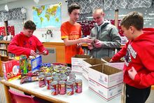 Bloomsburg Middle School Pride Leadership Team members, from left, Isaiah Verstraeten, Trevor Devine, Trent Munson and Garrett Brosious pack boxes which will be shipped to members in the military overseas. Missing from the photo is Daniel Yarnell. 