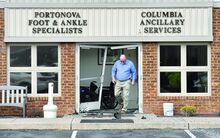 Press Enterprise/Jimmy May Ty Williams, administrator at the Susquehanna Valley Diagnostic Imaging, walks through the door of one of the offices in the complex Wednesday morning after a vehicle smashed through the doors. 