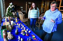 Diane Wasser. right, on Saturday, talks about her collection of about 200 Nativities, now on display in the lobby of Good Shepherd Lutheran Church in Berwick. Standing behind her is her daughter, Caroline Wasser. 