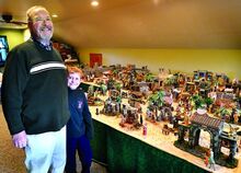 John Capozzelli and his grandson, Luke Frantz, 8, stand by the retired computer engineer’s Christmas story layout at his Salem Township home on Saturday. 