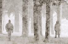 Two people walk through a blizzard at a park along Silver Lake in Virginia, Minn. Saturday.