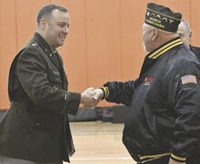 Kip McCabe, at right, with the Berwick VFW, shakes the hand of Lt. Col. Jonathan Barbee at Tuesday’s Veterans Day program at the Berwick YMCA. Barbee was the event’s guest speaker.
