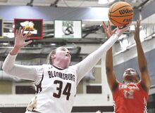 Bloomsburg University’s Alison Hatajik, left, gets her hand on the rebound between the hands of Lincoln’s Jasmine Shelton during the first quarter of Tuesday evening’s game at Bloomsburg. The Huskies won, 71-41.