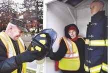 Hank and Deb Henrickson, right, set up the firefighter in a display of first responders in Berwick's Christmas Boulevard. Motorists are asked to drive with care along Market Street this week while volunteers are working on the islands and often stepping into the street.