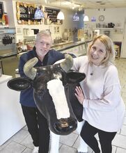 Brian and Debbie Brennan stand with Rosie the cow inside the Big Chill on Thursday. The last day in business for their Bloomsburg ice cream shop is today.