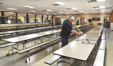 Southern Columbia custodian Dave Forgotch cleans in the high school cafeteria. The room is included on a list of recommended renovations.