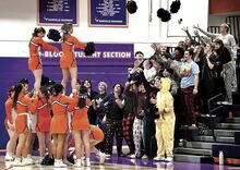 Danville cheerleaders make two “baskets” while fellow students toss the cheerleaders’ pom-poms into the “baskets” between the first and second quarters of the boys basketball game with Central Columbia at Danville Saturday night. Danville won in overtime 61-54.