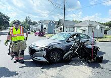 Bloomsburg firefighters clean up after a crash at the intersection of West Main and Railroad streets Sunday afternoon. Police say Jadyn Hudak, 20, of Bethlehem was driving the sedan when she pulled off Railroad Street to turn left and head east on Main Street. She pulled into the path of a Honda motorcycle driven by Scott Powell, Stillwater. Powell was taken to the hospital but did not appear seriously injured, police say.