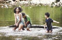 Children bounce on a log wedged in Fishing Creek at the Hoffman Natural Area in Bloomsburg on Sunday afternoon. From left in top photo are Yazlin Casalinova, 10; Asher Torres, 6; and Prince Lopez, 7, all of Mount Carmel.