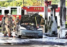 Firefighters from Valley Township, assisted by Liberty and Mahoning townships, extinguish a car fire that spread to a gas pump, at left, at the Mobil station off Route 54. It’s just south of Interstate 80 in Valley Township.