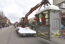 The Grinch hangs from an excavator in a Beaver Valley Environmental portable restroom jail during Berwick’s Annual Santa Parade on Friday morning.