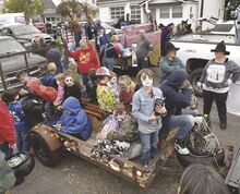 Kids fill floats sitting on West Third Street in Berwick Wednesday evening while waiting to take part in the annual Halloween parade.