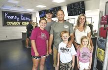 Dan and Amanda Keeney stand in their recently opened Keeney Farms Cowboy Cone, in photo at left above, with four of their five children. From left are Jorja, 12; Jaegen, 19; and twins Jase and Jentry, 7. Not in the picture is Jaxon, 16, who his dad said was “probably fishing.”