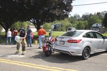 Emergency crews clean the road, top photo, as Lifeflight takes motorcyclist Jonathan Warke, Kutztown, to Geisinger Medical Center around 3:30 p.m. Sunday after a crash on state Route 93 around 2:55 p.m.