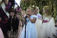 Ella Dinelli sings Let it Go into the microphone as (from left to right) Amelia Gordon, Isabella Moses, Cora Moll and Railyn Devine join her during the Little Bloomers Contest on Saturday in The Keystone Agricultural Building during the Bloomsburg Fair.