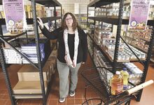 Montour Food Bank's Jillian Brandon stands among the shelves of items after helping about 200 people. Her food bank and others in the area are adjusting to shifting food bank funding. 