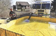 Summerhill Fire Company uses a port-a-pond to supply water, top photo, as tankers keep the water source full while fighting a fire Monday morning at 392 Shickshinny Valley Road in Briar Creek Township.