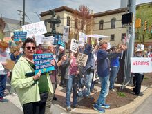 Dozens of protesters gathered Saturday in front of the town fountain at Market Square opposing policies of the Trump Administration