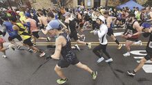 Runners take off on Market Street in Berwick as the 115th Run for the Diamonds gets underway in the rain Thursday.