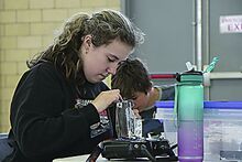 Josie Weible, 21, of Benton, a member of the Infectious Intelligence Combat Robot Club at the Bloomsburg Children’s Museum, repairs her robot, Poindexter, Saturday at the Battle in the Burg 2025 held in the Bloomsburg Fairgrounds’ Industrial Building.