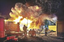Sparks and flames light up the night sky over a burning commercial building in Orangeville late Friday.