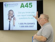 George Dillman, consumer outreach specialist with the Pennsylvania Department of Banking and Securities, talks about different types of scams that the elderly are targets of during Fraud Bingo at the Montour County Administrative building.