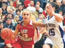 Mount Carmel's Ali Varano, left, drives toward the basket against Dunmore's Maddie Martin Friday in Hazleton. 