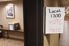 A sign hangs outside a Buckhorn hotel room where unionized Autoneum employees had 24 hours to vote on authorizing a strike at the Bloomsburg company.