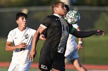 Southern Columbia's Isaac Carter gathers the ball at midfield while being defended by Berwick’s Kevin Ayala during the first half of a boys soccer game Thursday evening at Southern Columbia.
