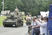 A World War II-era Stuart tank drives by during Saturday’s parade at Test Track Park in Berwick.