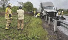 Mifflin Fire Chief Allen Mausteller and Manroop Singh survey the wreckage of Singh’s truck and the three vehicles it hit on Interstate 80 Sunday.