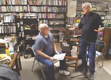Rand Whipple, at right, tells Steve Bevans what will take place as Bevans does his reading for Whipple’s “Locals Jr.” podcast in the basement of the Bloomsburg Public Library Friday.
